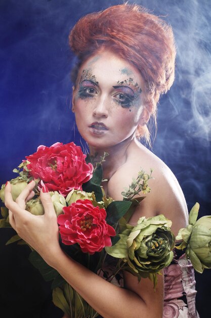 Beautiful redhair woman holding flowers