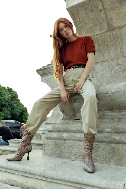 Beautiful redhead woman posing on the street