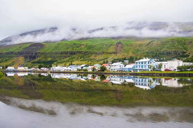 Beautiful Reflection of Houses, Church, Highway and Rainbow Road in Seydisfjordur Town in Iceland