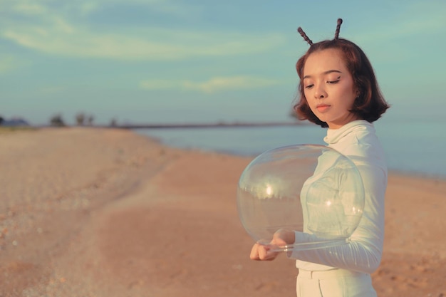 Beautiful Retro space girl holding helmet space