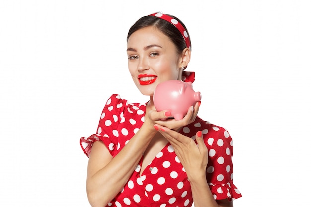 Beautiful retro woman hold piggy bank