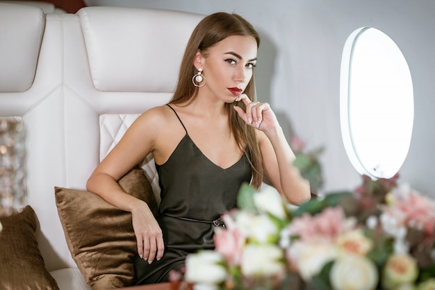 Beautiful rich woman in a private first class plane