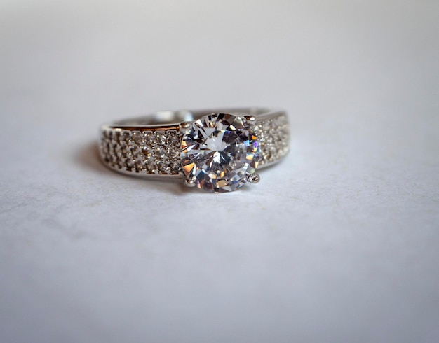 Beautiful ring made of silver or white gold with a stone on a\
white background