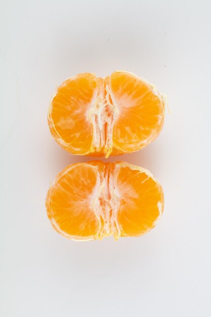 Beautiful ripe peeled tangerine on a white background