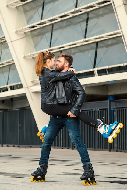 Beautiful roller skater couple with hipster style skating after the rain.