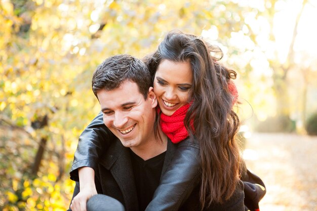 Beautiful romantic couple in autumn park having fun