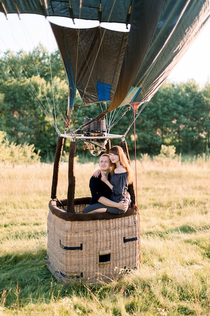 Beautiful romantic couple in hot yellow air balloon