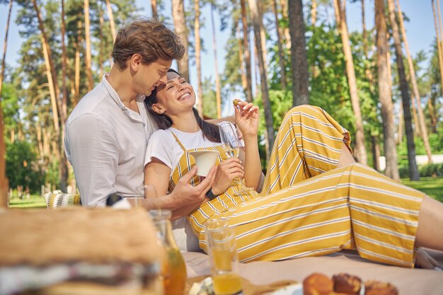 beautiful romantic couple spending time in the green forest in the sunshine day