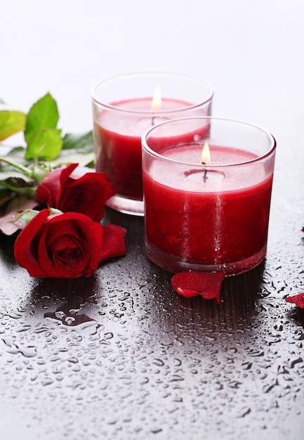 Beautiful romantic red candles with flowers, close up