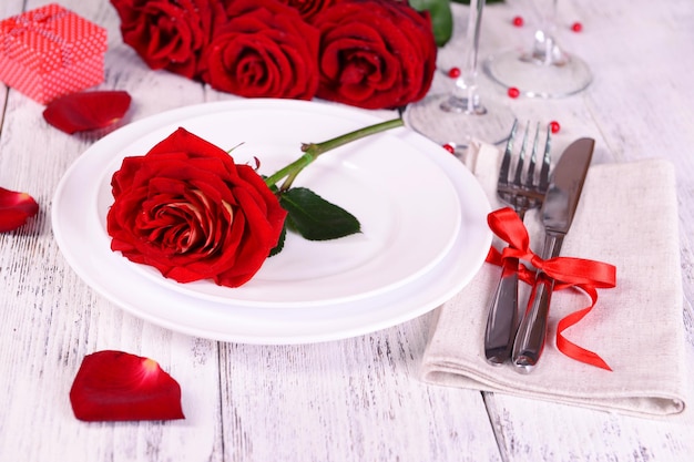 Beautiful romantic table setting with red roses close-up