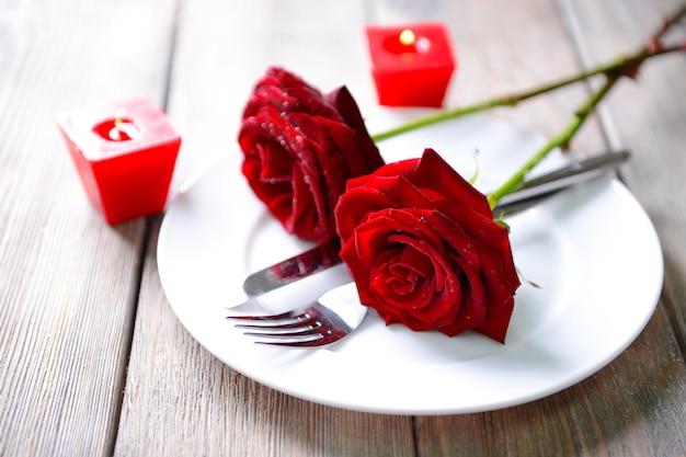 Beautiful romantic table setting with red roses close-up