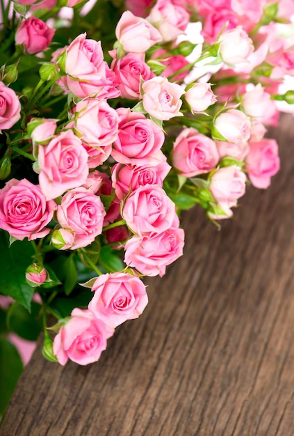 Beautiful Roses Bouquet Flowers on wooden background