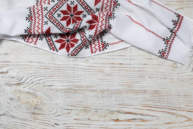 Photo beautiful rushnyk on white wooden table top view with space for text ukrainian national embroidery