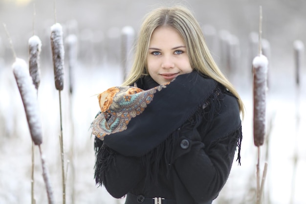 Beautiful Russian woman in a scarf in winter