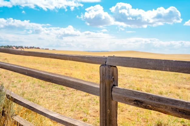 Beautiful rustic landscape with field and wooden fence