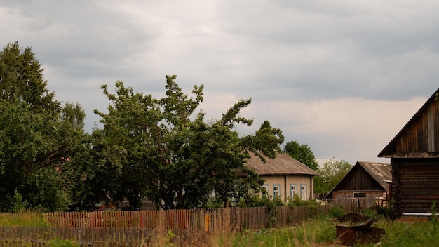 Beautiful rustic summer landscape Old wooden log houses Vologda region