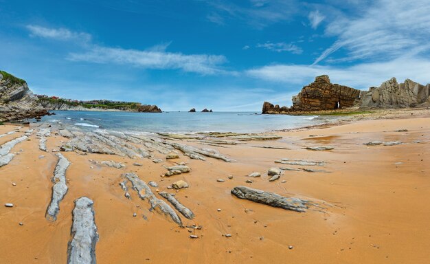 Beautiful sandy Playa Del Portio Biskaya Cantabria Spain summer landscape Atlantic Ocean coastline view with rock formations