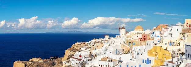 Beautiful Santorini in Greece - traditional windmill and apartments in Oia village