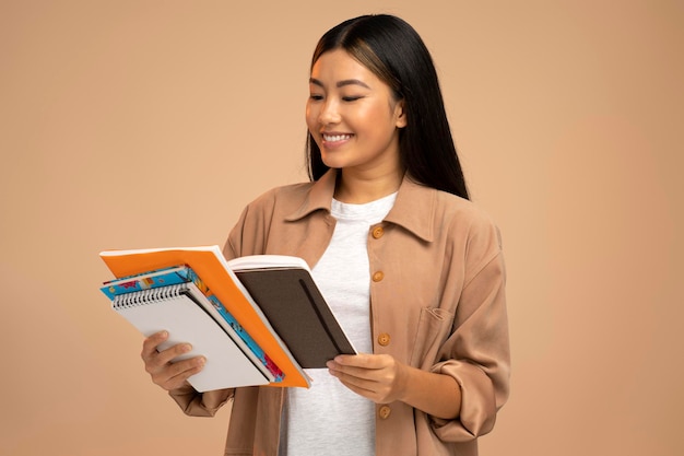 Beautiful satisfied woman holding and reading book likes genre and plot