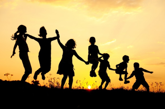 Beautiful scene of children jumping in nature