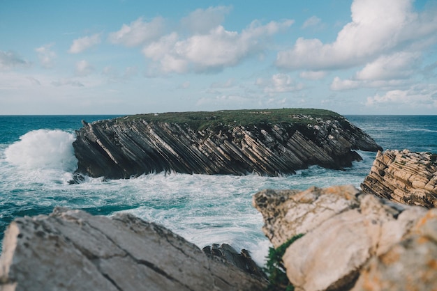 A beautiful scenery of Baleal islands in Peniche, Portugal under the fluffy clouds