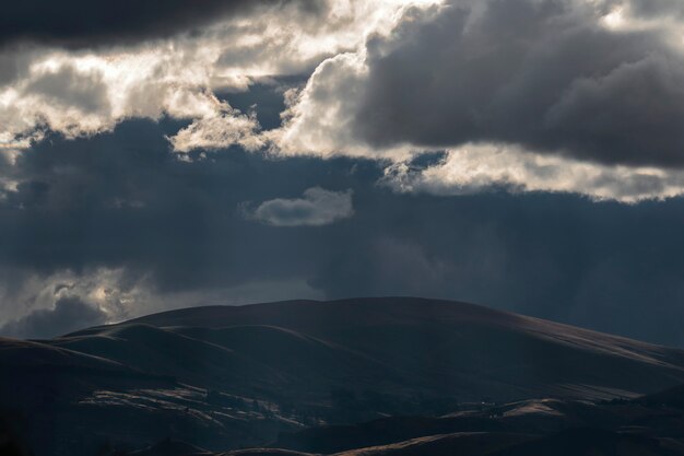 Beautiful scenery of mountainous landscape at sunset with dramatic and cloudy sky in the Mantaro Valley in the central region of the Peruvian Andes.