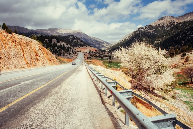 Beautiful scenic highway in mountains. Car rides on asphalt surf