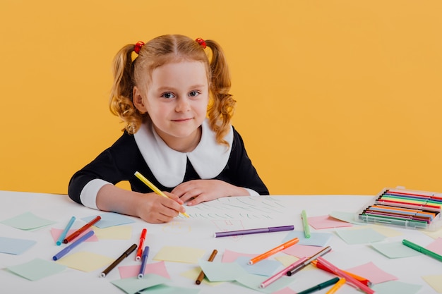 Beautiful schoolgirl wearing a uniform drawing