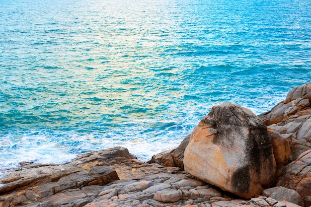 Beautiful Seascape blue sea and rocky shore at sunset Travel and tourism Wallpaper