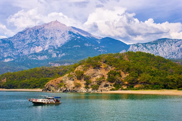 Beautiful seascape. summer day in a bay with mountains and fantastic sky and a boat. Turkey. Antalya.