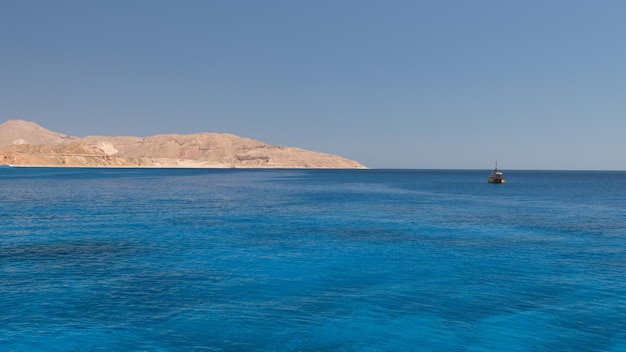 Beautiful seascape towards the shore with a yacht in the background