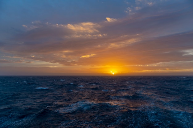 Beautiful seascape - waves and sky with clouds with beautiful lighting. Golden hour. Sunset at sea.