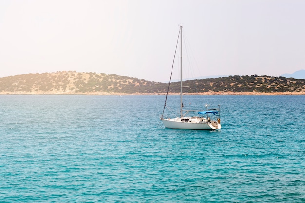 Beautiful seascape with white sailing yacht in the blue sea. 