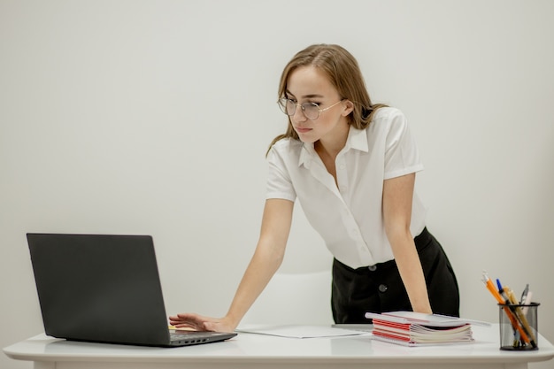 Beautiful secretary in spectacles is checking her boss is meeting to arrange another one