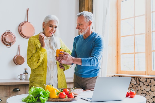 Beautiful senior couple of lovers.   Elderly people portrait while having fun at home