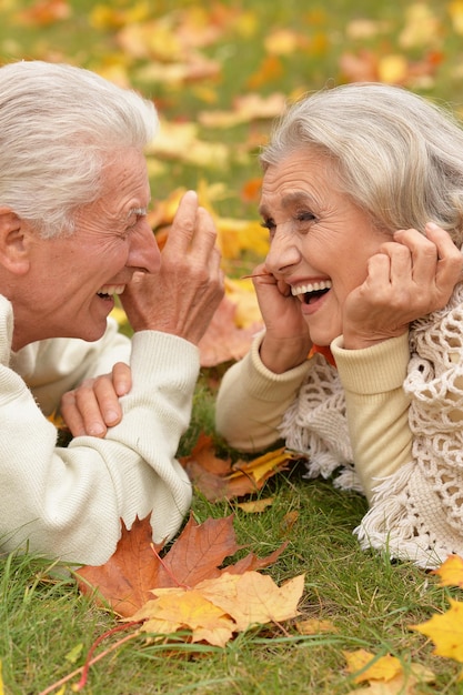 Beautiful senior couple posing and relaxing in the autumn park