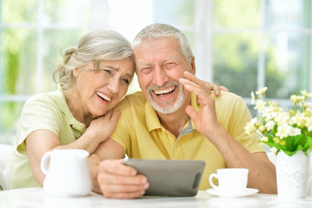 Beautiful senior couple using tablet