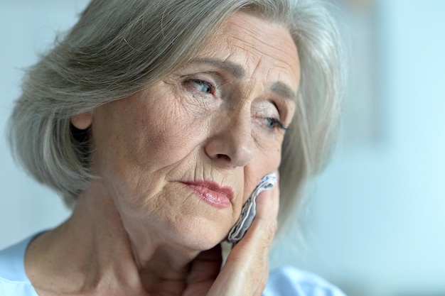 Beautiful senior sick woman at home