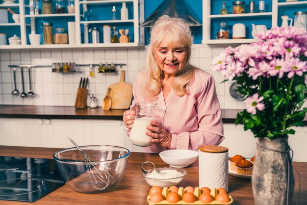 Beautiful senior woman baking in the kitchen 