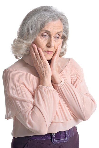 Beautiful senior woman in pink blouse isolated on white background