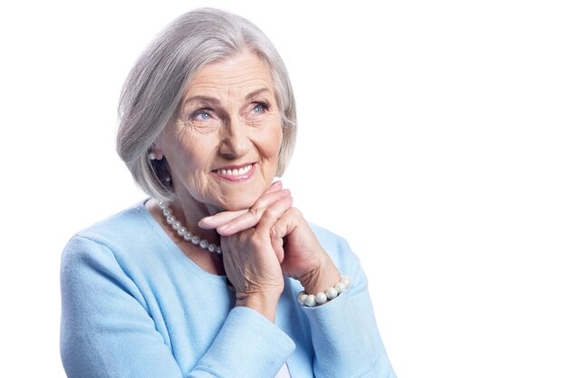 Beautiful senior woman posing on white background