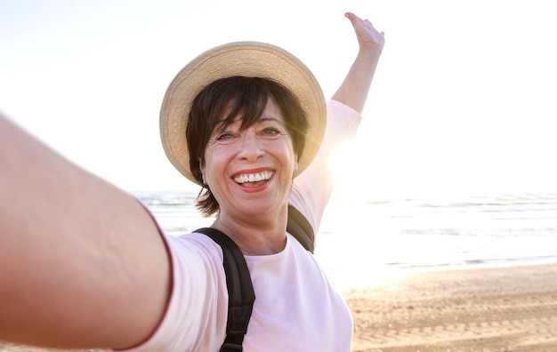 Beautiful senior woman taking selfie outside