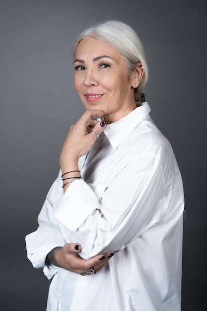 Beautiful senior woman in white blouse