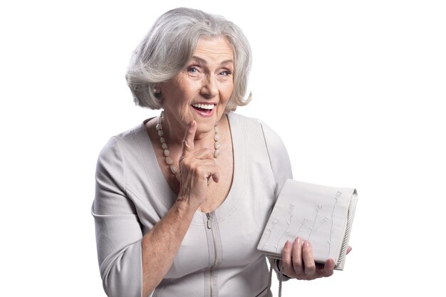 Beautiful senior woman with purse posing isolated