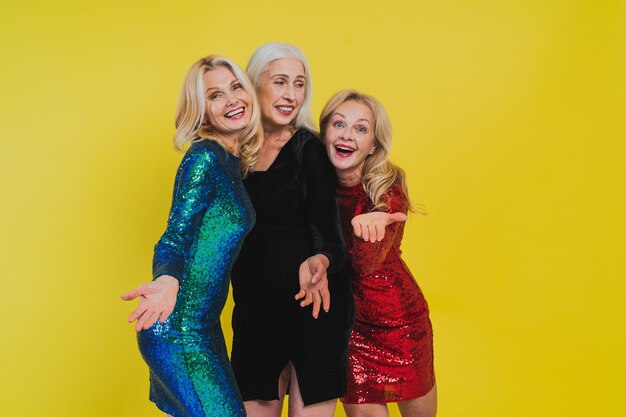 Beautiful senior women with festive elgant dress having fun at a party