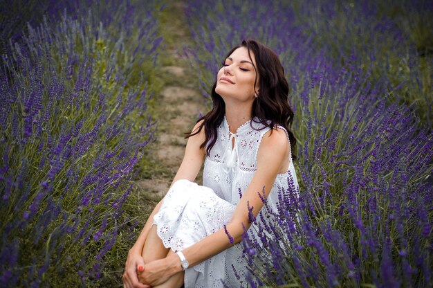 Beautiful sensual woman portrait outdoor in flowers field