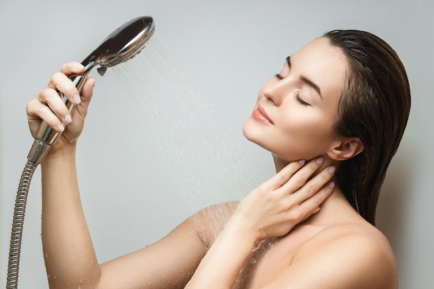 Beautiful sensual woman washing under shower spray