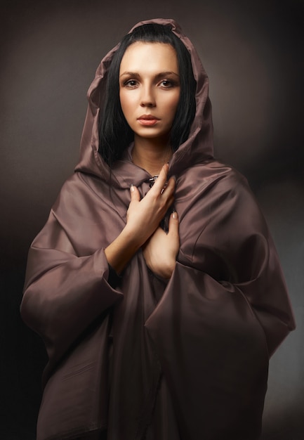 Beautiful sensual young brunette woman in brown robe