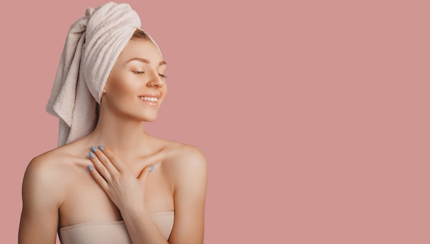 beautiful sensual young girl with clean skin on a pink surface