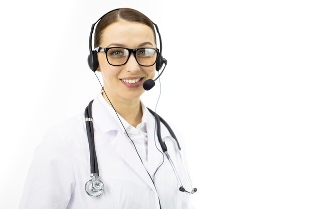 Beautiful sexy female doctor in white coat, headset